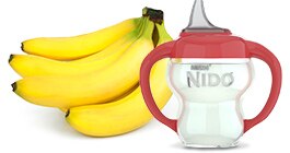 A bunch of bananas beside a NIDO sippy cup.