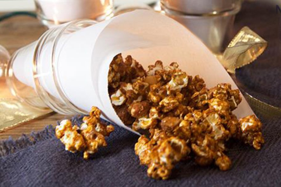A parchment cone filled with dulce de leche popcorn.