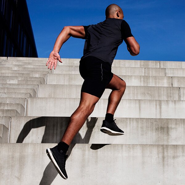 A man sprints up cement steps.
