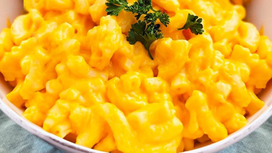 A bowl of Stouffer’s Macaroni and Cheese with an herb garnish.