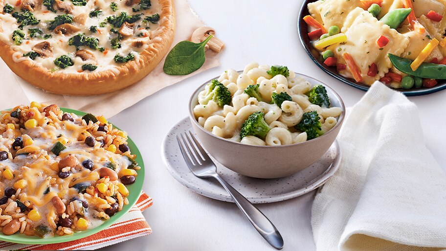 Dishes of Santa Fe-Style Rice & Beans, Spinach & Mushroom Pizza and Butternut Squash Ravioli sit by Garlic Parmesan Alfredo.