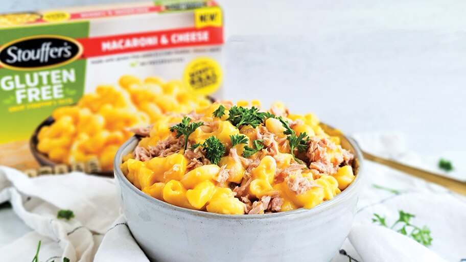 A box of Stouffer's gluten free macaroni and cheese next to a bowl of macaroni with tuna mixed in.