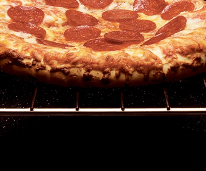 A pepperoni pizza on an oven rack.