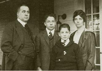 A black and white picture of the Stouffer family on heir front porch.