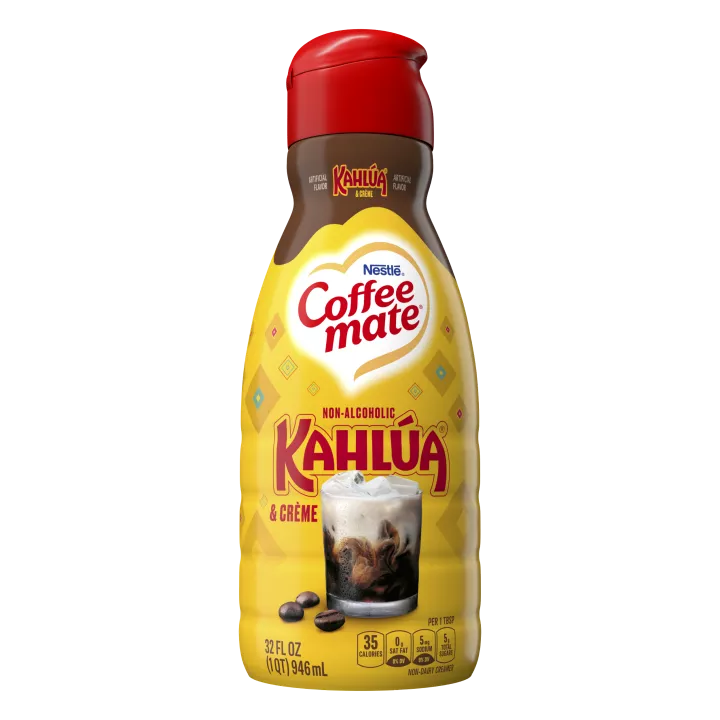 A yellow bottle of Kahlúa & Créme flavored coffee creamer with the Kahlúa logo above a glass of coffee with cream.