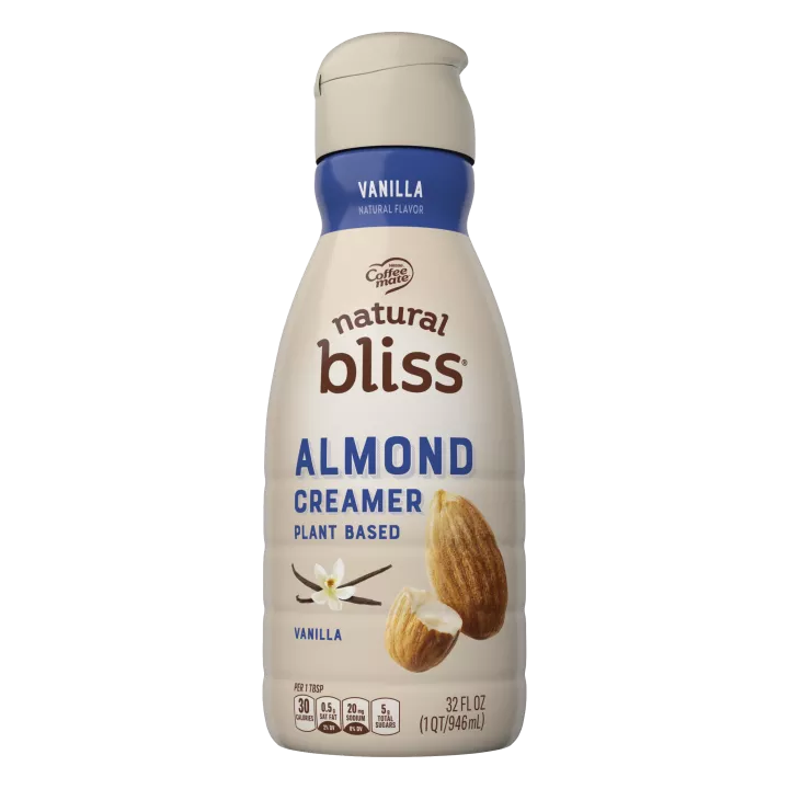 A beige bottle of natural bliss vanilla flavor almond milk creamer with a blue label above vanilla beans and almonds.