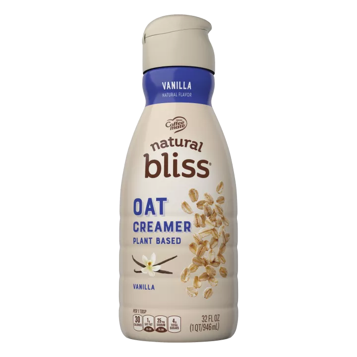 A brown bottle of natural bliss Vanilla Flavored Oat Milk Creamer with a blue label above vanilla beans and oats.
