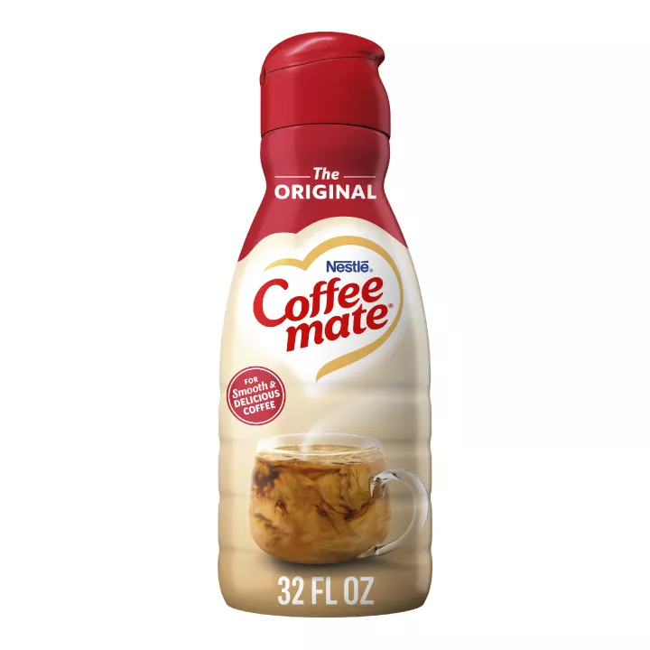 A bottle of Original Creamer with a red label above a coffee mug, biscotti and the product logo.
