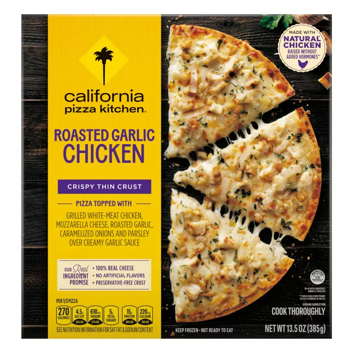 Box of Roasted Garlic Chicken Pizza with half a pizza, chicken and the natural chicken badge on a black wooden surface.