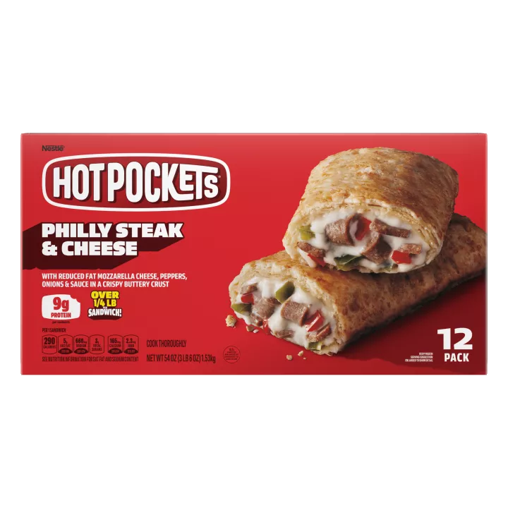 Left angle view photograph of a box of Philly Steak & Cheese Hot Pockets® featuring the red and white Hot Pockets logo above the product name and two golden brown seasoned crusts stuffed with Philly steak, peppers, onions, and melted mozzarella cheeses on a bright red surface with a “12 Pack” label in the bottom right corner.