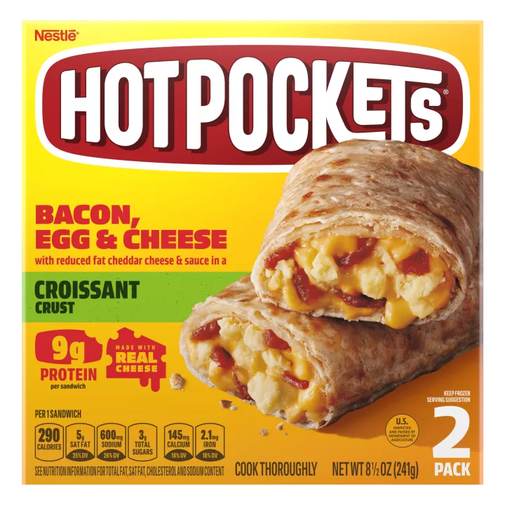 A yellow box of Bacon, Egg & Cheese Hot Pockets with a croissant crusted sandwich on a green label.