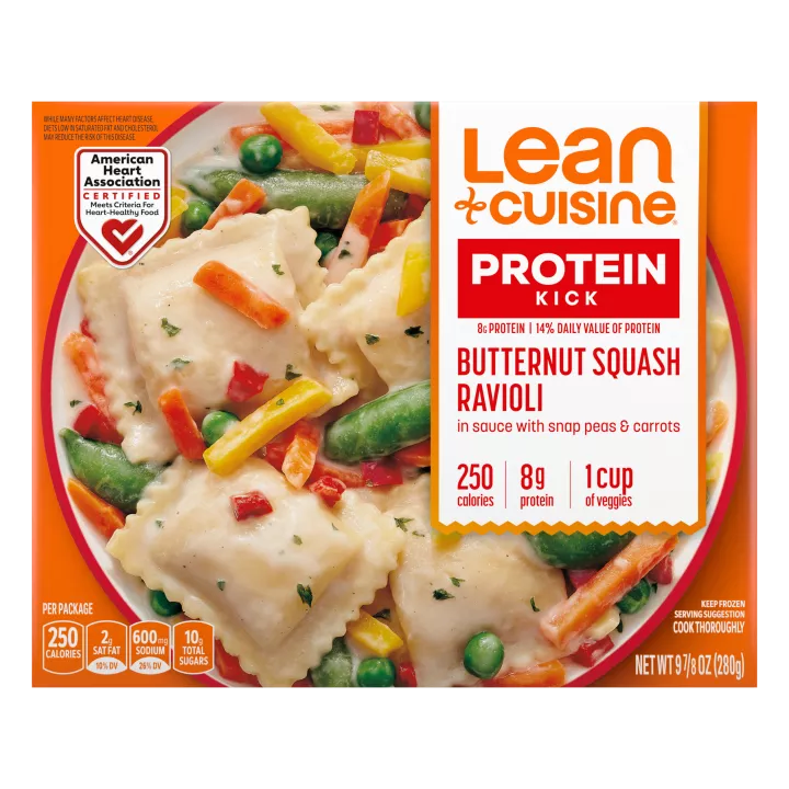 A box of Butternut Squash Ravioli with a Protein Kick label near a bowl of squash ravioli, snap peas, peppers, and carrots.