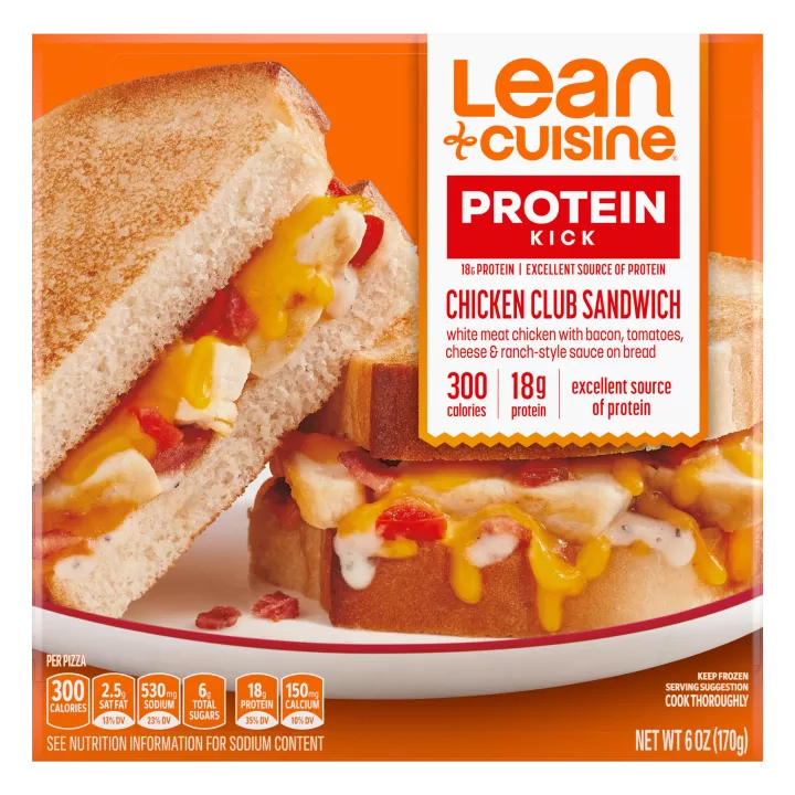 A box of Chicken Club Sandwich with a Protein Kick label near a cooked sandwich cut in half.