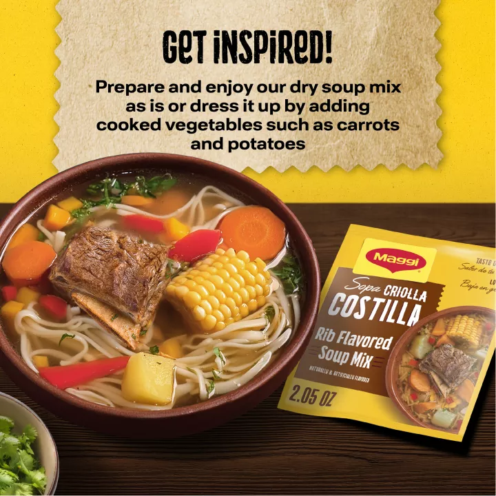 Left angle view of packaging for MAGGI Criolla Beef Noodle Soup mix with a red label beside a stack of garlic, tomato, and celery with a green field above and a big orange bowl filled with beef, corn cob, noodle, and celery.