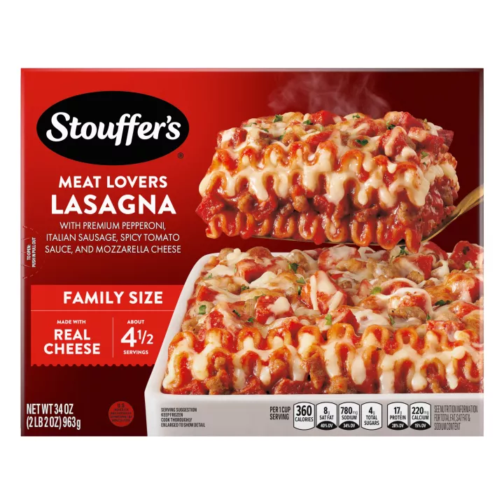 Box of Meat Lovers Lasagna with a plate of lasagna near a dish, the product name, STOUFFER'S logo and "FAMILY SIZE" label.
