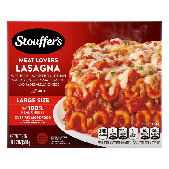 A plate of Meat Lovers Lasagna on a table below the product name, Large Size label, STOUFFER'S logo and "17g PROTEIN" label.