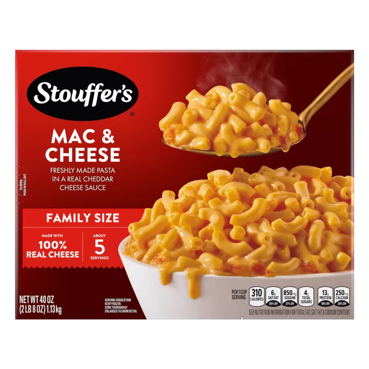 Box of Macaroni & Cheese with a plate and dish of mac & cheese on a table near the product name and "100% REAL CHEESE" label.