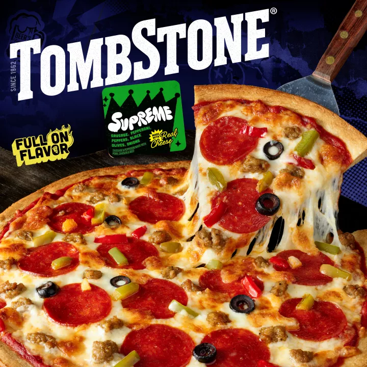 Package of original supreme pizza with a green label and border, a spatula under a pizza, and the Tombstone logo.