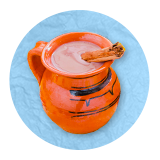 Close up of an orange mug on a blue background.