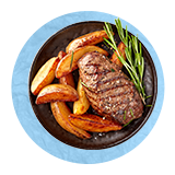 Overhead of a sirloin steak, roasted carrots, and a sprig of thyme on a black plate, on a blue background.