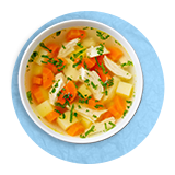  Overhead of a bowl of chicken soup with noodles and carrots, on a blue background.