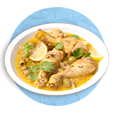  Close up of chicken stew in a white bowl, on a blue background.