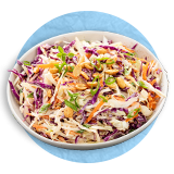 Close up of coleslaw in a in a white bowl, on a blue background.