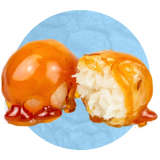 Close up of a pair of candy coated apples on a blue background.