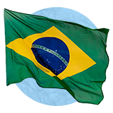 Brazilian flag waving in the wind on a blue background.
