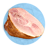 Close up of a roasted ham, on a blue background.
