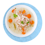 Overhead of a bowl of turkey broth soup, on a blue background.
