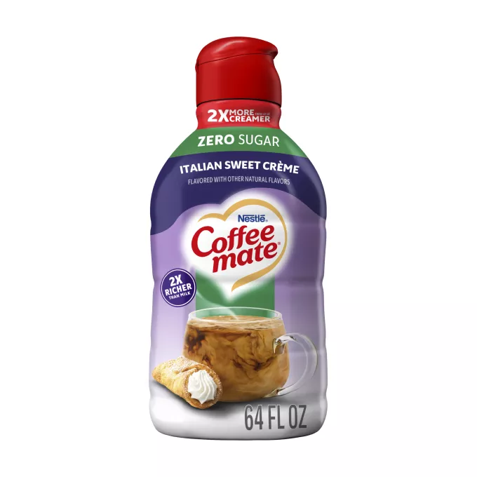 A purple bottle of Italian Sweet Crème Creamer with a green “Zero Sugar” label above a coffee mug and cannoli.