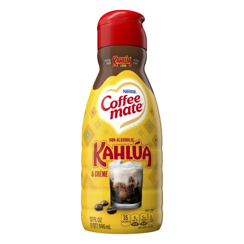 A yellow bottle of Kahlúa & Créme flavored coffee creamer with the Kahlúa logo above a glass of coffee with cream.
