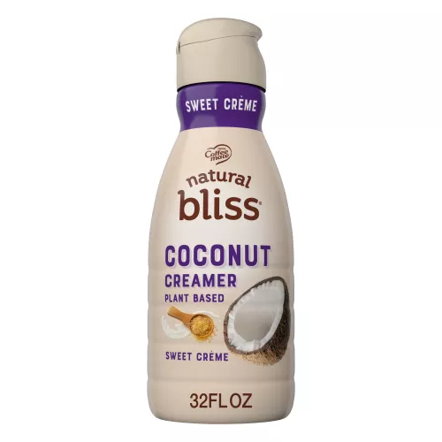 A beige bottle of natural bliss Coconut Milk Sweet Crème Creamer with a purple label above the product name and a coconut.