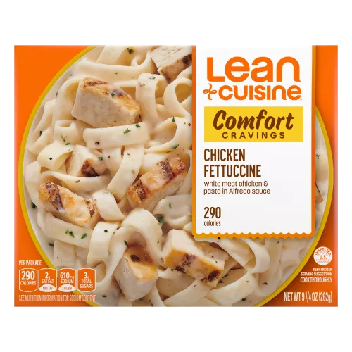 A box of Chicken Fettuccine with a Comfort Cravings label near a bowl of Fettuccine and chicken covered with alfredo sauce.