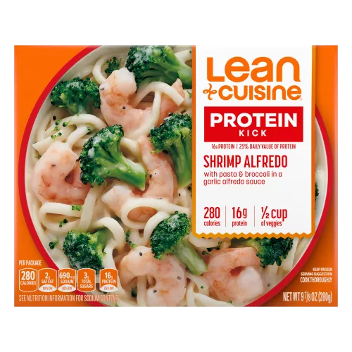 A box of Shrimp Alfredo with Protein Kick label with 280 calories, 16 grams of protein and half cup of veggies near a bowl of shrimp, broccoli, pasta, with Alfredo sauce.
