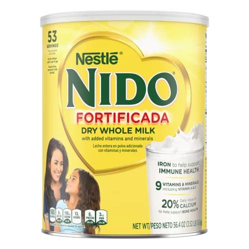 A canister of Nido Fortificada with a yellow label, white lid and gold heart above a glass of pouring milk.