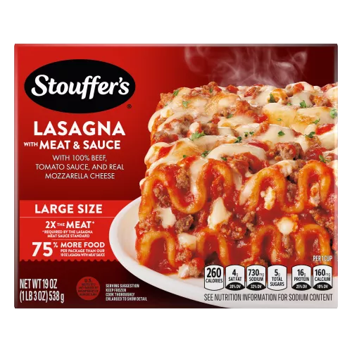 A plate of Lasagna with Meat & Sauce on a table below the product name, Large Size label, and "2x the Meat" label.