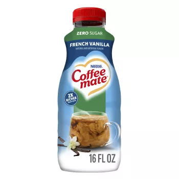 A blue bottle of Zero Sugar French Vanilla Coffee Creamer with a Zero Sugar label above a coffee mug and vanilla beans.