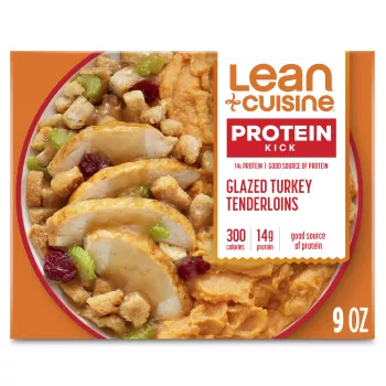 A box of Glazed Turkey Tenderloins with a Protein Kick label near a bowl of turkey tenderloins, sweet potatoes, and stuffing.