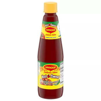 Bottle of Hot and Sweet Tomato Chili Sauce with a bright yellow and green label with tomatoes and hot peppers.