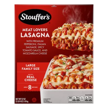 A plate of Meat Lovers Lasagna beside a red dish of lasagna on a table below the product name, and "4 Delicious Meats" label.