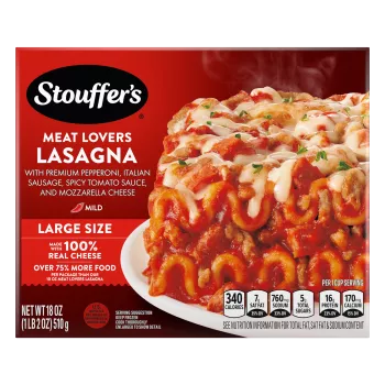 A plate of Meat Lovers Lasagna on a table below the product name, Large Size label, STOUFFER'S logo and "17g PROTEIN" label.