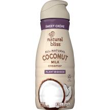 Una botella beige de creamer Coconut Sweet Creme de natural bliss con una etiqueta morada encima de un coco y el logotipo del producto.