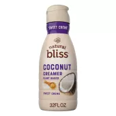 A beige bottle of natural bliss Coconut Milk Sweet Crème Creamer with a purple label above the product name and a coconut.