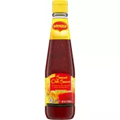 A bottle of Sweet Chili Sauce with a bright red and yellow label and egg rolls beside a cup of sauce.