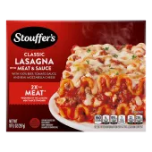A plate of Lasagna with Meat & Sauce on a table below the product name, STOUFFER'S logo and "2x the Meat" label.