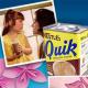 A Polaroid picture and pink flower are behind a vintage can of Nestlé Quik. 