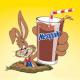 The NESQUIK Bunny pops out of a hole with a glass of chocolate milk.